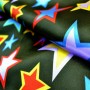 Carnival satin fabric - stars on black background