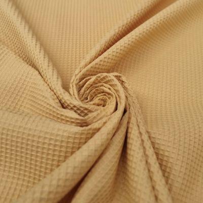Ochre embossed cotton piqué fabric
